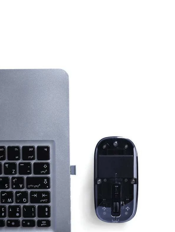 Nuvello Transparent Rechargeable Wireless Mouse, transparent mouse beside laptop